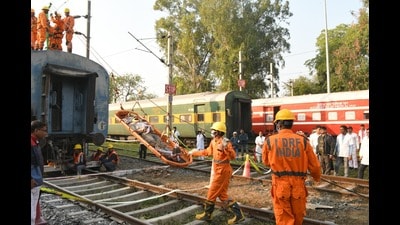 NDRF team rescuing trapped passengers from the accident site near Aishbagh depot in a mock drill on Tuesday. (HT Photo)