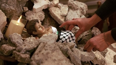 A woman arranges an installation of a scene of the nativity of Christ withith a figure "symbolising baby Jesus lying in his manger amid rubble", in reference to Gaza, inside the the Evangelical Lutheran Church in Bethlehem in the occupied West Bank, a few weeks before Christmas. Palestinian town of Bethlehem faces ‘worst Christmas ever’ as Israel war scares away tourists and pilgrims (Photo by HAZEM BADER / AFP) A woman arranges an installation of a scene of the nativity of Christ withith a figure "symbolising baby Jesus lying in his manger amid rubble", in reference to Gaza, inside the the Evangelical Lutheran Church in Bethlehem in the occupied West Bank, a few weeks before Christmas. Palestinian town of Bethlehem faces ‘worst Christmas ever’ as Israel war scares away tourists and pilgrims (Photo by HAZEM BADER / AFP)