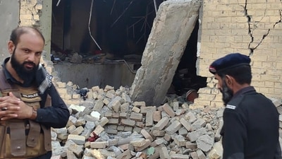 Police officers examine damages on the site of a bombing at a police station on the outskirts of Dera Ismail Khan, Pakistan, Tuesday, Dec. 12, 2023 (AP) Police officers examine damages on the site of a bombing at a police station on the outskirts of Dera Ismail Khan, Pakistan, Tuesday, Dec. 12, 2023 (AP)