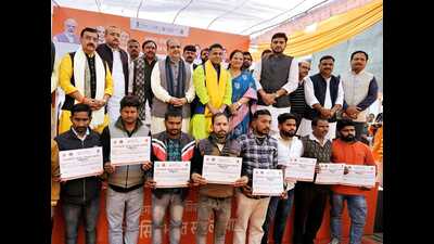 UP BJP chief Bhupendra Chaudhary with beneficiaries during Viksit Bharat Sankalp Yatra in Lucknow. (HT Photo)