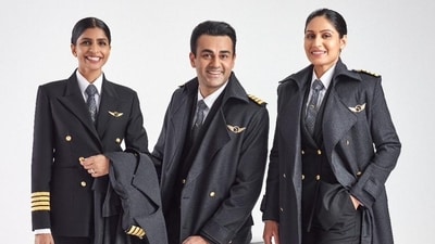 The uniform designed for the cockpit crew of Air India. It consists of a classic black double-breasted suit adorned with a print inspired by the Vista, Air India's new logo icon. This print not only adds a touch of contemporary design but also symbolizes the enduring and serious nature of the aviation profession. The combination of the classic suit and the Vista-inspired print aims to convey a sense of authority and sophistication for the cockpit crew. (Air India) The uniform designed for the cockpit crew of Air India. It consists of a classic black double-breasted suit adorned with a print inspired by the Vista, Air India's new logo icon. This print not only adds a touch of contemporary design but also symbolizes the enduring and serious nature of the aviation profession. The combination of the classic suit and the Vista-inspired print aims to convey a sense of authority and sophistication for the cockpit crew. (Air India)