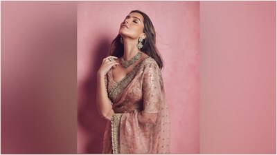 Tara styled the saree with a matching mauve-coloured blouse featuring a boat-plunging neckline, mirror embellishments, floral embroidery, gota patti work, quarter-length sleeves, fitted bust, and a cropped hem. An ornated gold choker necklace, matching jhumkis, a statement ring, and high heels gave a finishing touch. (Instagram) Tara styled the saree with a matching mauve-coloured blouse featuring a boat-plunging neckline, mirror embellishments, floral embroidery, gota patti work, quarter-length sleeves, fitted bust, and a cropped hem. An ornated gold choker necklace, matching jhumkis, a statement ring, and high heels gave a finishing touch. (Instagram)