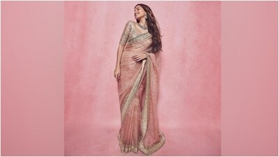 Celebrity stylist Meagan Concessio took to Instagram to share pictures of Tara Sutaria. "Pretty in pink," Meagan captioned the post. The photos show the actor posing in a gorgeous pink saree and embroidered blouse. The ensemble is from the shelves of the clothing label A&B by Rhea Kapoor. Read our download on it below. (Instagram) Celebrity stylist Meagan Concessio took to Instagram to share pictures of Tara Sutaria. "Pretty in pink," Meagan captioned the post. The photos show the actor posing in a gorgeous pink saree and embroidered blouse. The ensemble is from the shelves of the clothing label A&B by Rhea Kapoor. Read our download on it below. (Instagram)