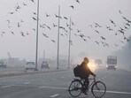 People are going to their work amid cold and smoggy weather at South-West Delhi near Samalkha Chowk(HT File Photo/Parveen Kumar)