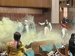 An India TV video grab shows the scenes inside the Lok Sabha after an unidentified man jumped from the visitors’ gallery, evaded MPs, and released coloured smoke. (ANI) An India TV video grab shows the scenes inside the Lok Sabha after an unidentified man jumped from the visitors’ gallery, evaded MPs, and released coloured smoke. (ANI)