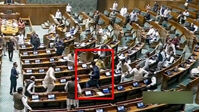 A video grab shows an unidentified man jumping from the visitor's gallery of Lok Sabha. (ANI) A video grab shows an unidentified man jumping from the visitor's gallery of Lok Sabha. (ANI)