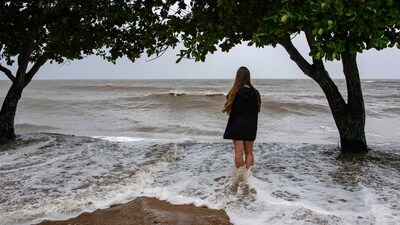 A Holloways Beach resident watches the storm across the Coral Sea as Cyclone Jasper approaches landfall in Cairns in far north Queensland on December 13. (AFP) A Holloways Beach resident watches the storm across the Coral Sea as Cyclone Jasper approaches landfall in Cairns in far north Queensland on December 13. (AFP)