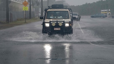 A motorist drives through floodwater as Cyclone Jasper approaches landfall in Cairns on Wednesday. (AFP) A motorist drives through floodwater as Cyclone Jasper approaches landfall in Cairns on Wednesday. (AFP)