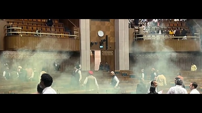 An India TV video grab shows the scenes inside the Lok Sabha after an unidentified man jumped from the visitors’ gallery, evaded MPs, and released coloured smoke. (ANI) An India TV video grab shows the scenes inside the Lok Sabha after an unidentified man jumped from the visitors’ gallery, evaded MPs, and released coloured smoke. (ANI)