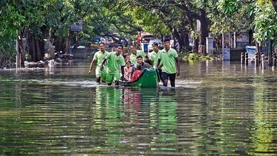 Emergency services personnel evacuate stranded residents from a flooded colony after heavy rainfall owing to Cyclone Michaung, at Mylapore in Chennai, on Wednesday. (PTI) Emergency services personnel evacuate stranded residents from a flooded colony after heavy rainfall owing to Cyclone Michaung, at Mylapore in Chennai, on Wednesday. (PTI)
