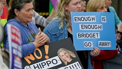 Protestors hold signs in favour of the public education support group Support Our Schools calling for the resignation of Sarasota County School Board member Bridget Ziegler, who is also co-founder of conservative parents group Moms for Liberty, during a rally in Sarasota, Florida, U.S. December 12, 2023.  REUTERS/Steve Nesius (REUTERS)
