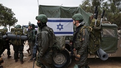 Israeli soldiers prepare to enter the Gaza Strip, amid the ongoing conflict between Israel and the Palestinian Islamist group Hamas, at Israel's border with Gaza in southern Israel. (Reuters)