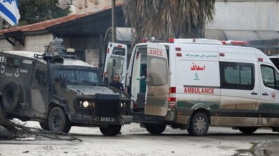 Israel-Hamas War: An Israeli military vehicle blocks an ambulance on the road during a raid in Jenin. (Reuters)