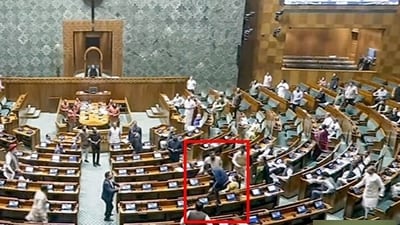 A video grab shows an unidentified man jumping from the visitor's gallery of Lok Sabha, after which a slight commotion occurred in the House during the Winter Session of Parliament, in New Delhi on Wednesday. (ANI) A video grab shows an unidentified man jumping from the visitor's gallery of Lok Sabha, after which a slight commotion occurred in the House during the Winter Session of Parliament, in New Delhi on Wednesday. (ANI)