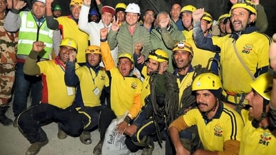 Uttarakhand Chief Minister Pushkar Singh Dhami and Union Minister of State VK Singh with rescue officials after the successful evacuation of 41 workers from the collapsed Silkyara Tunnel. (PTI) Uttarakhand Chief Minister Pushkar Singh Dhami and Union Minister of State VK Singh with rescue officials after the successful evacuation of 41 workers from the collapsed Silkyara Tunnel. (PTI)