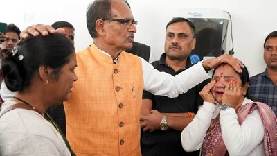 Shivraj Singh Chouhan with Ladli Laxmi Yojana beneficiaries in Bhopal on Tuesday. (PTI) Shivraj Singh Chouhan with Ladli Laxmi Yojana beneficiaries in Bhopal on Tuesday. (PTI)
