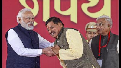 Prime Minister Narendra Modi being greeted by new Madhya Pradesh chief minister Mohan Yadav during the latter’s swearing-in ceremony, in Bhopal, Wednesday. Madhya Pradesh governor Mangubhai Patel is also seen. (PTI Photo) Prime Minister Narendra Modi being greeted by new Madhya Pradesh chief minister Mohan Yadav during the latter’s swearing-in ceremony, in Bhopal, Wednesday. Madhya Pradesh governor Mangubhai Patel is also seen. (PTI Photo)