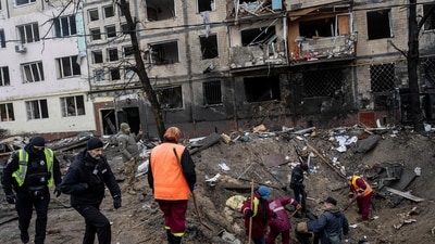 Russia-Ukraine War: Investigators look for fragments of a rocket inside a crater after a Russian rocket attack at a residential neighbourhood in Kyiv, Ukraine. (AP)