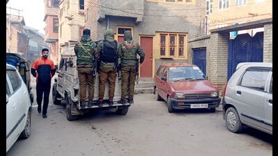 Security personnel during a raid by J&K Police's SIA in connection with a terror-related case, in Anantnag district on Wednesday. (PTI) Security personnel during a raid by J&K Police's SIA in connection with a terror-related case, in Anantnag district on Wednesday. (PTI)