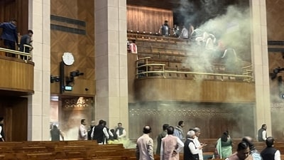 Footage captured from inside the chamber showed a chaotic scene as one man desperately hurdled desks, creating a frenzied atmosphere. His accomplice meanwhile unleashed a thick veil of smoke from the visitors' gallery, enveloping the Lok Sabha in a yellowish mist. Footage captured from inside the chamber showed a chaotic scene as one man desperately hurdled desks, creating a frenzied atmosphere. His accomplice meanwhile unleashed a thick veil of smoke from the visitors' gallery, enveloping the Lok Sabha in a yellowish mist.