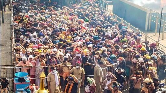 Ayyappa devotees wait to offer prayers at Sabarimala temple, in Pathanamthitta, on Wednesday. (PTI)
