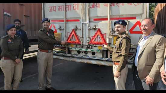 Mohali SSP Sandeep Garg and SP (traffic and industrial security) HS Mann during the installation drive of reflectors on commercial vehicles in Mohali. (HT)