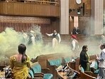 A video grab shows the scenes inside the Lok Sabha after an unidentified man jumped from the visitors’ gallery, evaded MPs, and released coloured smoke. (ANI) A video grab shows the scenes inside the Lok Sabha after an unidentified man jumped from the visitors’ gallery, evaded MPs, and released coloured smoke. (ANI)