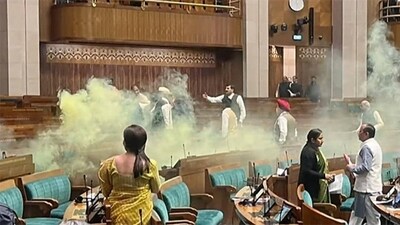A video grab shows the scenes inside the Lok Sabha after an unidentified man jumped from the visitors’ gallery, evaded MPs, and released coloured smoke. (ANI) A video grab shows the scenes inside the Lok Sabha after an unidentified man jumped from the visitors’ gallery, evaded MPs, and released coloured smoke. (ANI)