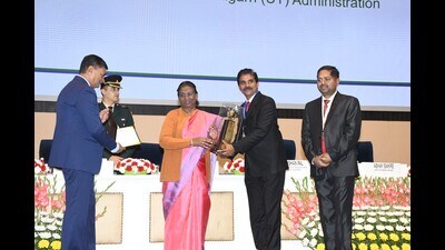 President Droupadi Murmu presenting the award to Dr Vijay Namdeorao Zade, secretary, finance/engineering, UT, and CB Ojha, chief engineer, engineering department, UT, at a function held at Vigyan Bhawan, New Delhi. (HT) President Droupadi Murmu presenting the award to Dr Vijay Namdeorao Zade, secretary, finance/engineering, UT, and CB Ojha, chief engineer, engineering department, UT, at a function held at Vigyan Bhawan, New Delhi. (HT)