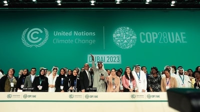 UN Climate Chief Simon Stiell, COP28 President Sultan al-Jaber and UAE chief negotiator Hana Al-Hashimi with others on Wednesday. (AP) UN Climate Chief Simon Stiell, COP28 President Sultan al-Jaber and UAE chief negotiator Hana Al-Hashimi with others on Wednesday. (AP)