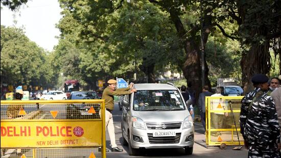 Police personnel inspect a vehicle as security tightens outside Parliament following the recent security breach that took place in Lok Sabha during the ongoing Winter Session in New Delhi on Thursday. (ANI)