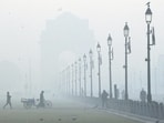 Workers at the lawn along the Kartavya Path during a cold and foggy winter morning, in New Delhi, Friday, Dec. 15, 2023. (PTI Photo/Arun Sharma) 