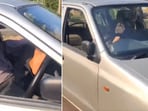 The image shows a man driving a car with his leg while sitting on passenger seat. The image shows a man driving a car with his leg while sitting on passenger seat.