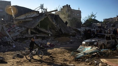 Palestinians search for bodies and survivors in the rubble of a residential building destroyed in an Israeli airstrike (AP) Palestinians search for bodies and survivors in the rubble of a residential building destroyed in an Israeli airstrike (AP)