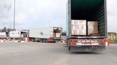 Humanitarian aid trucks wait in line to be inspected at the Kerem Shalom crossing, amid the ongoing conflict between Israel and the Palestinian Islamist group Hamas. (via REUTERS)