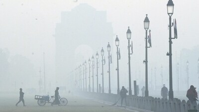 Workers at the lawn along the Kartavya Path during a cold and foggy winter morning, in New Delhi, Friday, Dec. 15, 2023. (PTI Photo/Arun Sharma) Workers at the lawn along the Kartavya Path during a cold and foggy winter morning, in New Delhi, Friday, Dec. 15, 2023. (PTI Photo/Arun Sharma)