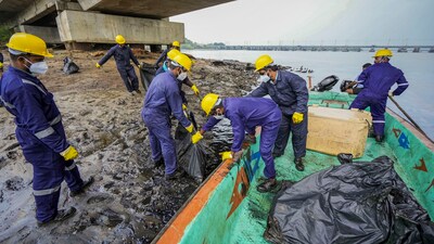 Chennai: Rescue officials clean after an oil spill in the Bay of Bengal off the Ennore Creek area in the aftermath of Cyclone Michaung, in Chennai, Friday. (PTI) Chennai: Rescue officials clean after an oil spill in the Bay of Bengal off the Ennore Creek area in the aftermath of Cyclone Michaung, in Chennai, Friday. (PTI)