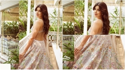 Shanaya wore the skirt with a sleeveless blouse featuring matching floral embroidery, sequin work, a plunging V neckline, an asymmetric midriff exposing hem, and broad shoulder straps. Lastly, a white net dupatta adorned with a scalloped hem and floral applique work on the borders gave the finishing touch. She draped it over her shoulder. (Instagram) Shanaya wore the skirt with a sleeveless blouse featuring matching floral embroidery, sequin work, a plunging V neckline, an asymmetric midriff exposing hem, and broad shoulder straps. Lastly, a white net dupatta adorned with a scalloped hem and floral applique work on the borders gave the finishing touch. She draped it over her shoulder. (Instagram)