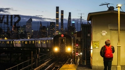A "7" line train arrives at Queensboro plaza station in Queens, New York, as the Manhattan midtown skyline looms in the distance, on December 6, 2023. (Photo by Charly TRIBALLEAU / AFP) (AFP) A "7" line train arrives at Queensboro plaza station in Queens, New York, as the Manhattan midtown skyline looms in the distance, on December 6, 2023. (Photo by Charly TRIBALLEAU / AFP) (AFP)
