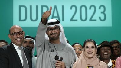United Nations Climate Chief Simon Stiell, from left, COP28 president Sultan Al-Jaber and Hana Al-Hashimi, chief COP28 negotiator for the UAE, pose for photos at the end of the COP28 UN Climate Summit, on Wednesday, in Dubai. (AP) United Nations Climate Chief Simon Stiell, from left, COP28 president Sultan Al-Jaber and Hana Al-Hashimi, chief COP28 negotiator for the UAE, pose for photos at the end of the COP28 UN Climate Summit, on Wednesday, in Dubai. (AP)