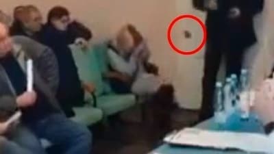 Video footage showed a man dropping grenades on the floor at a village council meeting (Telegraph)