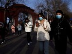 People, wearing masks to prevent coronavirus disease (COVID-19), walk along the street in Beijing, China, on February 14.