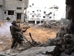 Israeli soldiers operate in the Gaza Strip amid the ongoing conflict between Israel and the Palestinian Islamist group Hamas, in this handout picture released on December 14, 2023. 