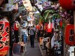 Japan Flu Cases: People wearing protective masks walk at a Japanese Izakaya pub alley, amid the coronavirus disease (Covid-19) outbreak, in Tokyo.