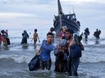 Ethnic Rohingya disembark from their boat upon landing in Ulee Madon, North Aceh, Indonesia, Thursday, Nov. 16, 2023.