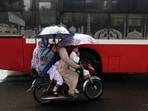 Pakistan Artificial Rain: A family rides a bike amid rain in Lahore. Pakistan Artificial Rain: A family rides a bike amid rain in Lahore.