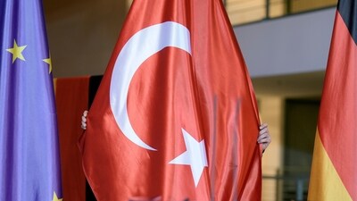 A worker prepares a Turkish flag ahead of a meeting of Turkey's President Recep Tayyip Erdogan and German Chancellor Olaf Scholz at the chancellery in Berlin, Germany, Friday, Nov. 17, 2023. (AP Photo/Markus Schreiber) (AP) A worker prepares a Turkish flag ahead of a meeting of Turkey's President Recep Tayyip Erdogan and German Chancellor Olaf Scholz at the chancellery in Berlin, Germany, Friday, Nov. 17, 2023. (AP Photo/Markus Schreiber) (AP)