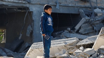 Israel-Hamas War: A Palestinian child looks on at the site of an Israeli strike on a house, amid the ongoing conflict between Israel and Hamas. (Reuters)