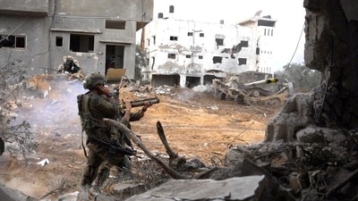 Israeli soldiers operate in the Gaza Strip amid the ongoing conflict between Israel and the Palestinian Islamist group Hamas, in this handout picture released on December 14, 2023. (Gaza)