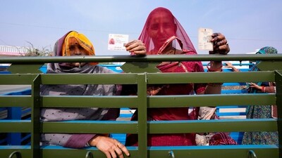 Women display their voter's identity card sitting in the back of a truck in Chachiyawas, near Ajmer, India, Saturday, Nov. 25, 2023. (AP)